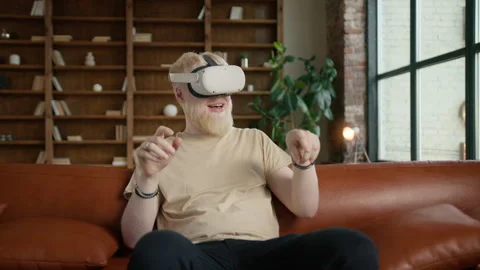 Bearded blonde man in VR headset looking around with smile exploring cyberspace Stock Footage 255111829