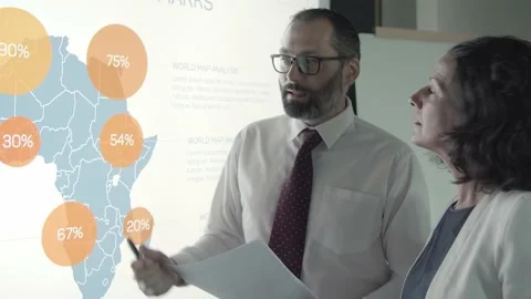 Bearded boss discussing analytics data with businesswoman Video stock 137513031