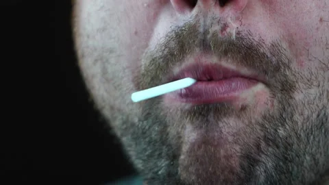 Bearded brutal man licks candy on a stick simulating oral sex Stock Footage 130222215