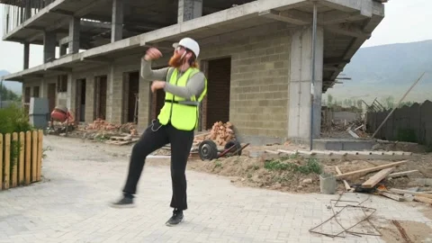 Bearded builder dancing enjoying successfully completed project Video stock 277179553