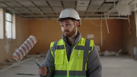 Bearded builder in hardhat is inspecting a construction site. An architect in Stock Footage 237183024