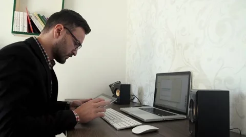 Bearded business man is working by pc in his office Stock Footage 57489613