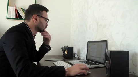 Bearded business man is working by pc in his office Stock Footage 57489830