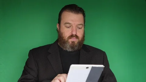 Bearded businessman is looking for something on the tablet Vídeo Stock 122263367