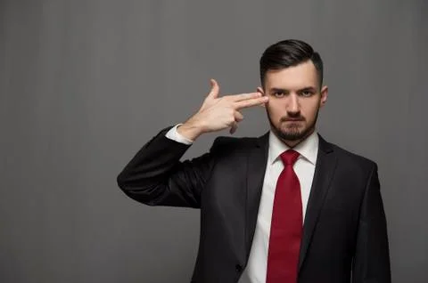 Bearded businessman posing on gray background Stock Photos