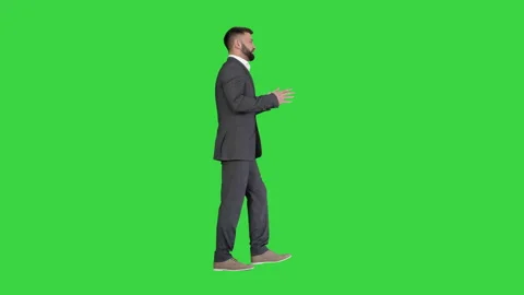 Bearded businessman walking and explaining something on a Green Screen, Chroma Stock-Footage 135959324