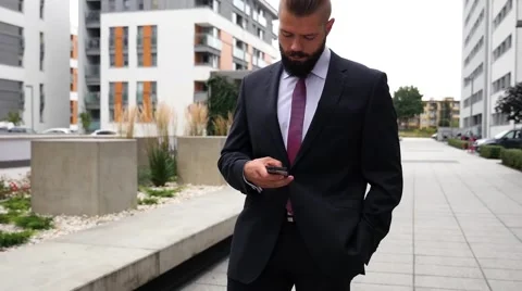 Bearded businessman writting e-mail using his mobile phone. Close up. Stock Footage 60945214