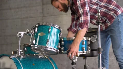 Bearded Casual Man is Setting Up A Drum Set  before Playing - Drum Lesson. Stock Footage 155554899