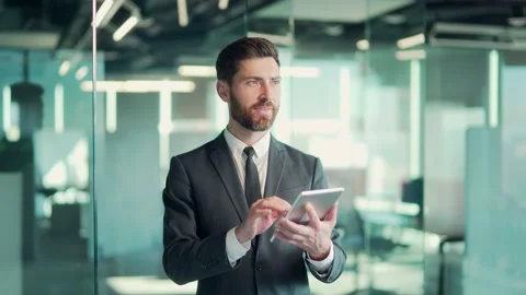 Bearded caucasian business man using tablet in modern office. Businessman male  Stock Footage 167863537