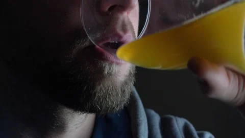 Bearded Caucasian Man Drinking Beer from Pint Glass on Dark Background Stock Footage 147963247