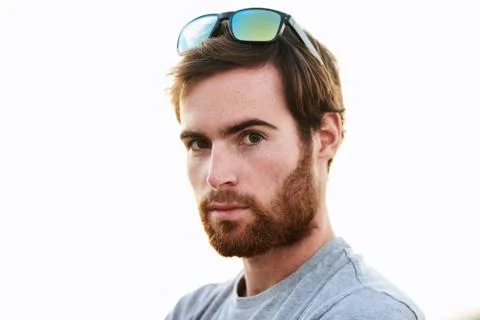 Bearded caucasian man looking into camera with sunglasses on head Stock Photos