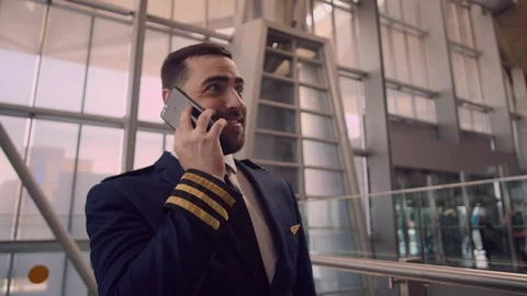 Bearded caucasian pilot in the uniform walking inside the airport terminal Stock Footage 109148795