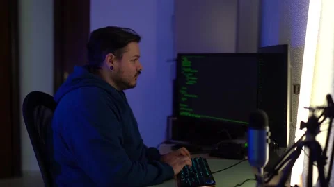 Bearded Caucasian programmer typing on his computer keyboard and working very Stock Footage 196765081