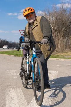 Bearded, chubby senior man getting ready to ride on gravel bicycle Stock Photos