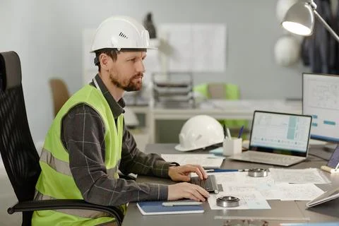 Bearded construction engineer in office using computer Stock Photos