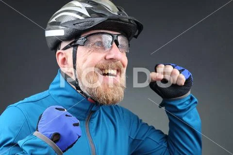 Bearded cyclist rejoices at victory. Stock Photos