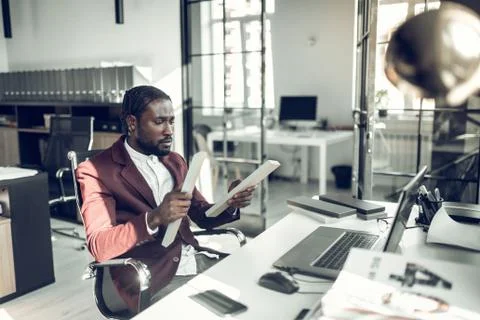 Bearded dark-skinned interior designer working on new project Stockfoto's