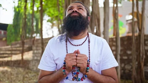 Bearded devotee chants prayer as meditating at retreat Stock Footage 303128030