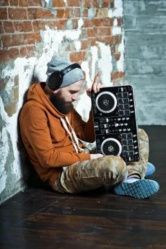 The bearded DJ. The guy in the hat and sneakers. Stock Photos