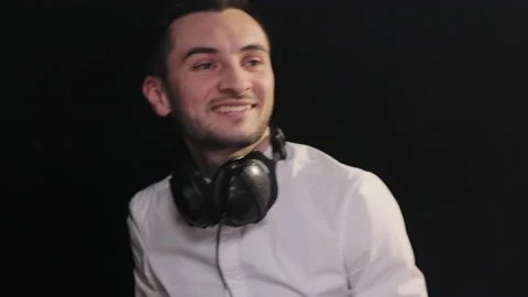 Bearded dj standing at the mixer controller, composing a new mix and rocking the Stock Footage 194759384