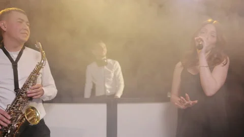 Bearded DJ standing at the mixer controller, composing a new mix the party in Video stock 194760627