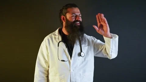 Bearded doctor gesturing laughing as talking in joy Video stock 304493550