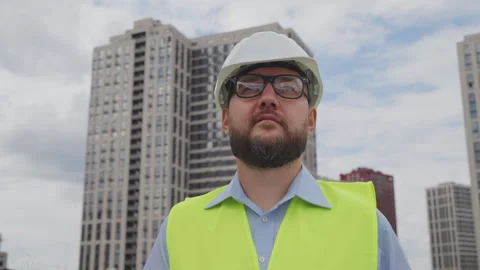 Bearded engineer making important notes on clipboard about completed work Stock Footage 252727948
