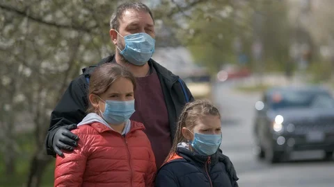 A bearded father and two daughters are standing on the street Stock Footage 129278830