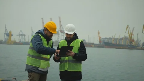 Bearded foreman and a contractor greet and discuss work Stock Footage 99354013