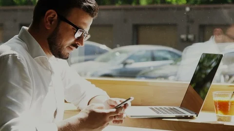Bearded freelancer in formal clothes working in cafe near window and having Stock Footage 112985464