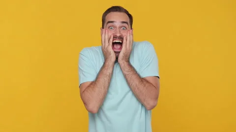 Bearded fun young guy 20s in basic casual blue t-shirt looking camera shocked Stock Footage 148285743
