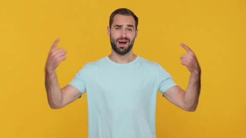 Bearded fun young man 20s in basic casual blue t-shirt pointing fingers himself Video stock 148289000