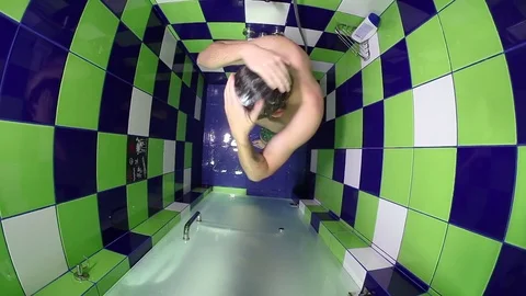 Bearded funny man spitting water from his mouth and washing ears Stock Footage 83557308