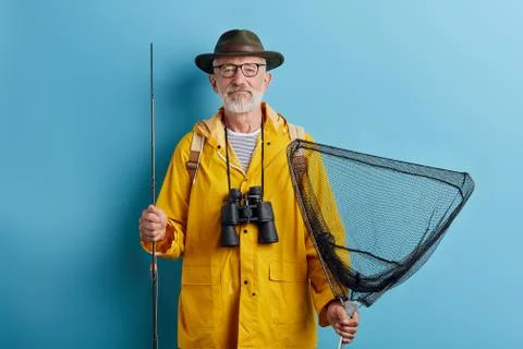 Bearded good looking old man holding fish tank and rod Stock Photos