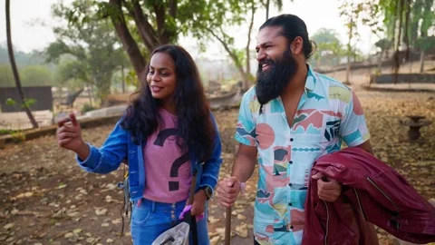 Bearded guy and a lady chat on nature trail outdoor Stock Footage 304502154