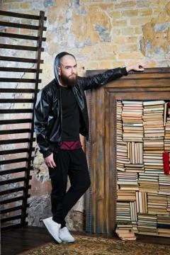 Bearded guy in the background of books Stock Photos