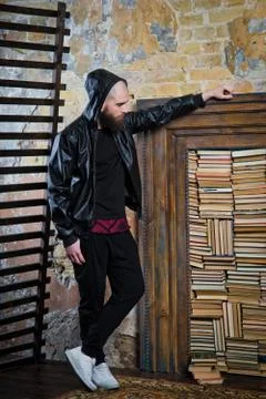 Bearded guy in the background of books Stock Photos