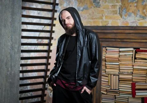 Bearded guy in the background of books Stock Photos