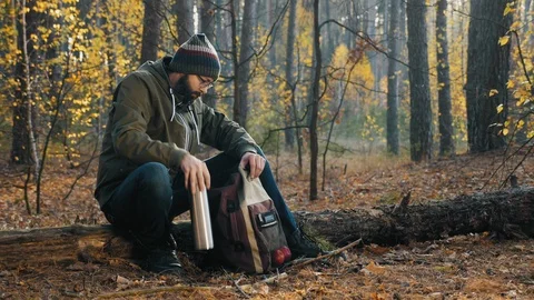 Bearded guy with a backpack in the autumn forest Stock Footage 119150342