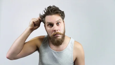 The bearded guy combs her hair and looks in the mirror. Stock Footage 122503370