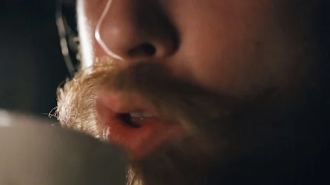 Bearded guy is drinking beer Video stock 75657206