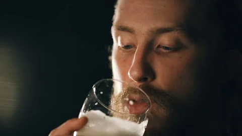Bearded guy is drinking beer Video stock 75657227
