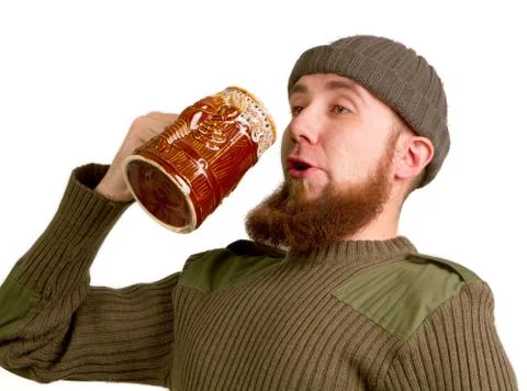 Bearded guy drinking beer from the glass Stock Photos
