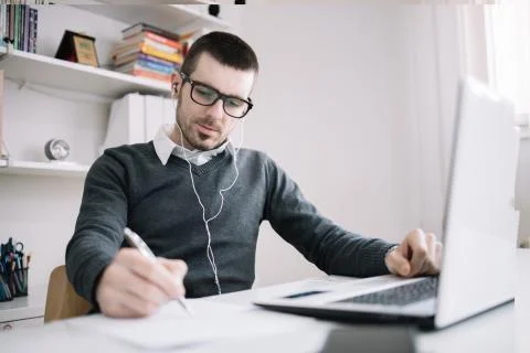 Bearded guy with glasses learning foreign languages Stock Photos