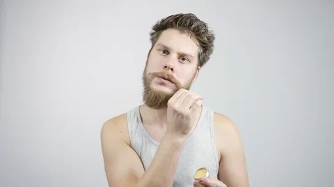 The bearded guy has been laying his mustache.Home care for a mustache Stock Footage 121687930