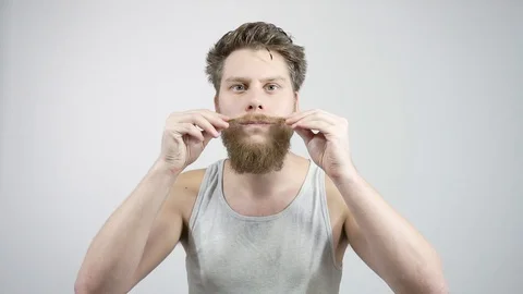 The bearded guy has been laying his mustache.Home care for a mustache Stock Footage 121688103
