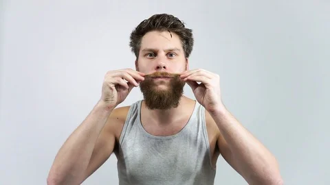 The bearded guy has been laying his mustache.Home care for a mustache Stock Footage 122504410