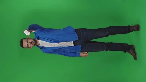 Bearded guy looks at camera and makes gesture with his finger down on isolated Stock Footage 170360260