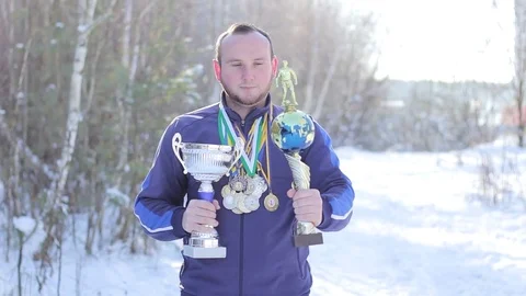 Bearded guy with medals and cups on football Stock Footage 85306402