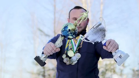 Bearded guy with medals and cups on football Stock Footage 85306897